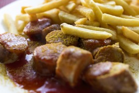 Stock Image: Traditional German currywurst - pieces of sausage with curry sauce