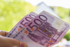 Stock Image: Two 500 euro notes in a hand - 1000 euro