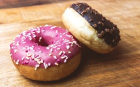 Stock Image: two delicious donuts on a wooden board