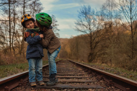 Stock Image: Two little brothers on an old disused railroad track