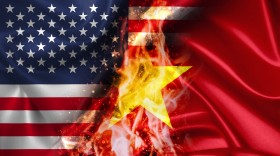 Stock Image: USA vs Vietnam burning Flag - conflict war comparison on fire illustration