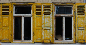 Stock Image: Vintage windows with yellow Shutters