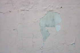 Stock Image: White exterior wall texture with cracked plastering
