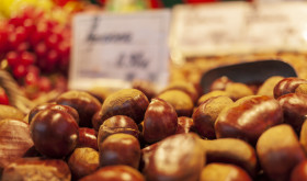 Stock Image: Wicker Basket full of sweet organic Chestnut at country market