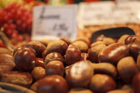 Stock Image: Wicker Basket full of sweet organic Chestnut at country market