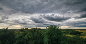 Stock Image: Wind farm dark storm clouds