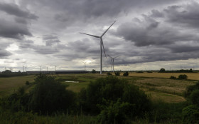 Stock Image: wind turbines between fields in germany