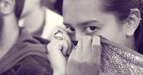 Stock Image: woman hides her face with the collar of her sweater