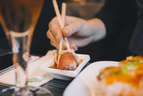 Stock Image: women eating sushi in japanese restaurant