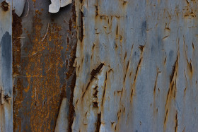 Stock Image: worn steel texture  blue paint rolls off