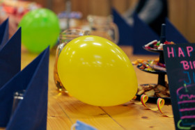 Stock Image: Yellow balloon on set birthday table