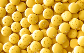 Stock Image: yellow drug pills ecstasy pills emoticon face happyness background