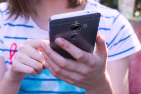 Stock Image: young girl with a smartphone in her hand