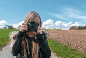 Stock Image: young girl with camera - female photographer